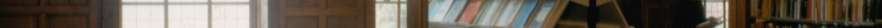 Looking at three students having conversations on chairs in the Earlham Hall library through a panel window