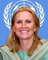 Dr. Monika Oledzka-Nielsen, in front of the UN logo