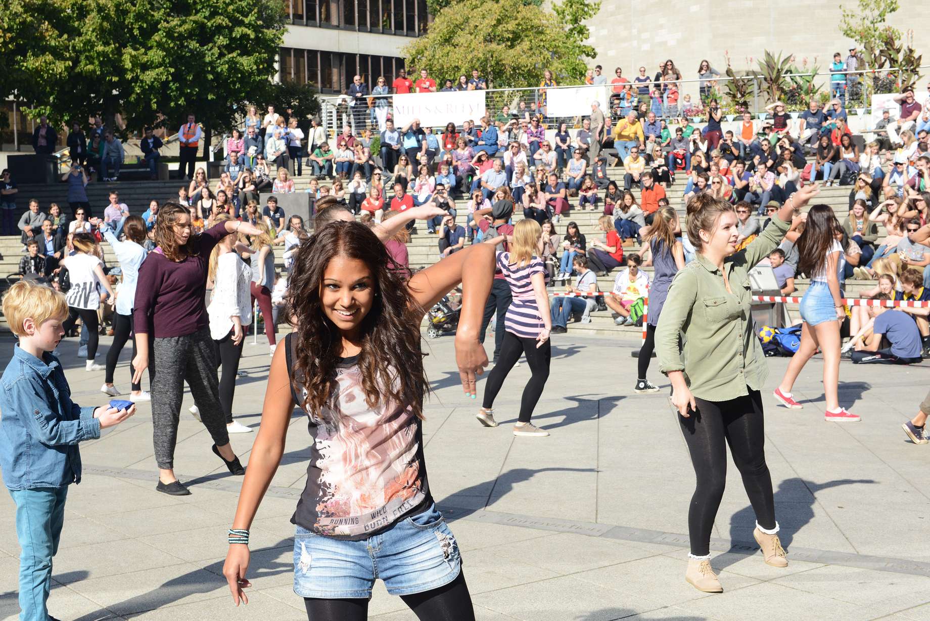 a group of people dancing to Thriller to onlooking spectators at the Square