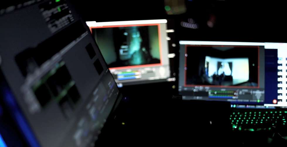 Three screens displaying what appears to be a theatre stage.