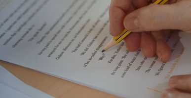 Someone uses a pencil to edit their work.