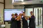 Four students from Diss High School lift the ScrapBot Olympics 2023 trophy.