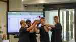 Four students from Diss High School lift the ScrapBot Olympics 2023 trophy.