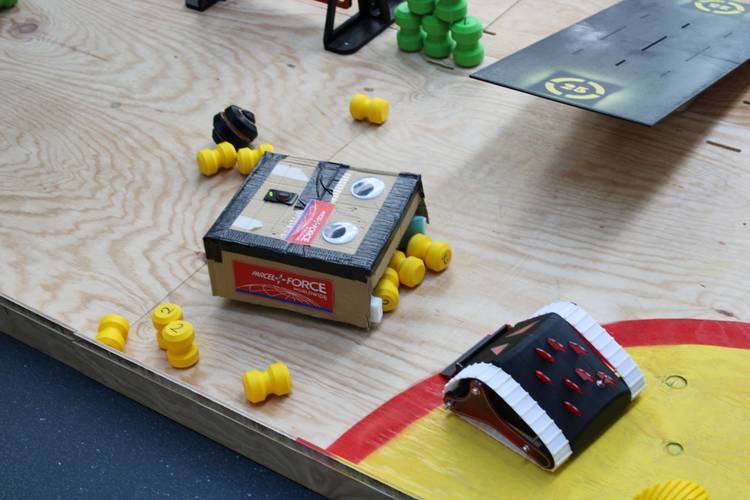 A ScrapBot made out of cardboard boxes competes in the Assault Course.