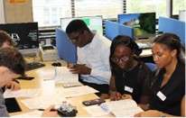 Students sat around a table looking at study notes