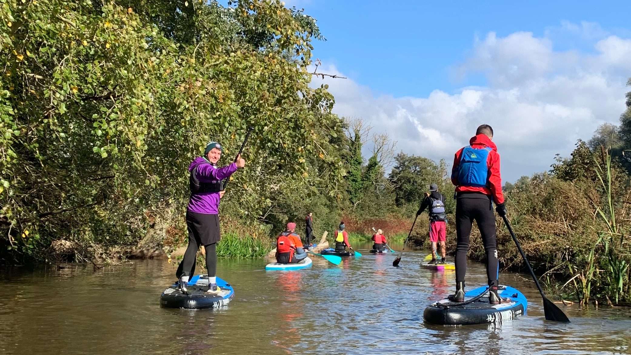 A group of people paddleboarding on a sunny day.