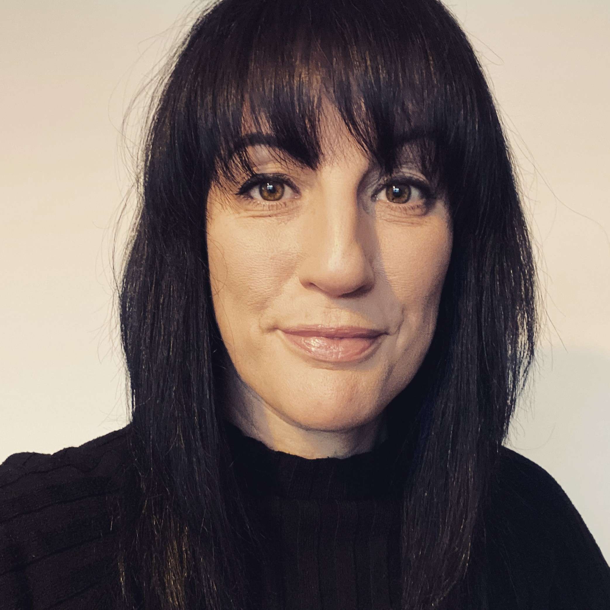 A portrait photo of someone smiling at the camera.