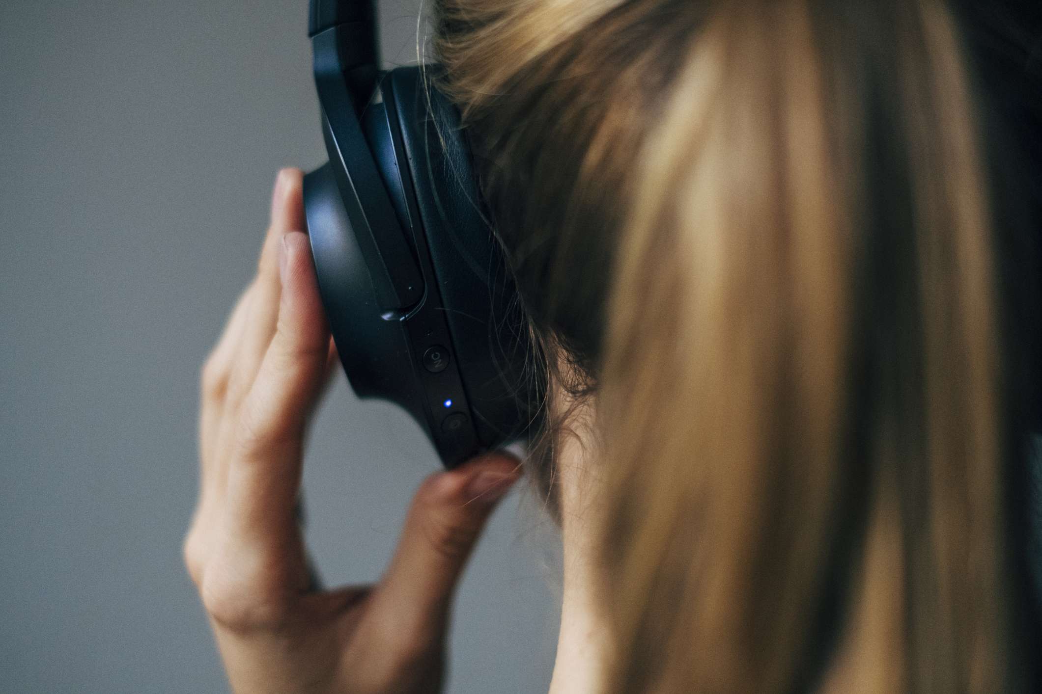 woman placing headphones on her head