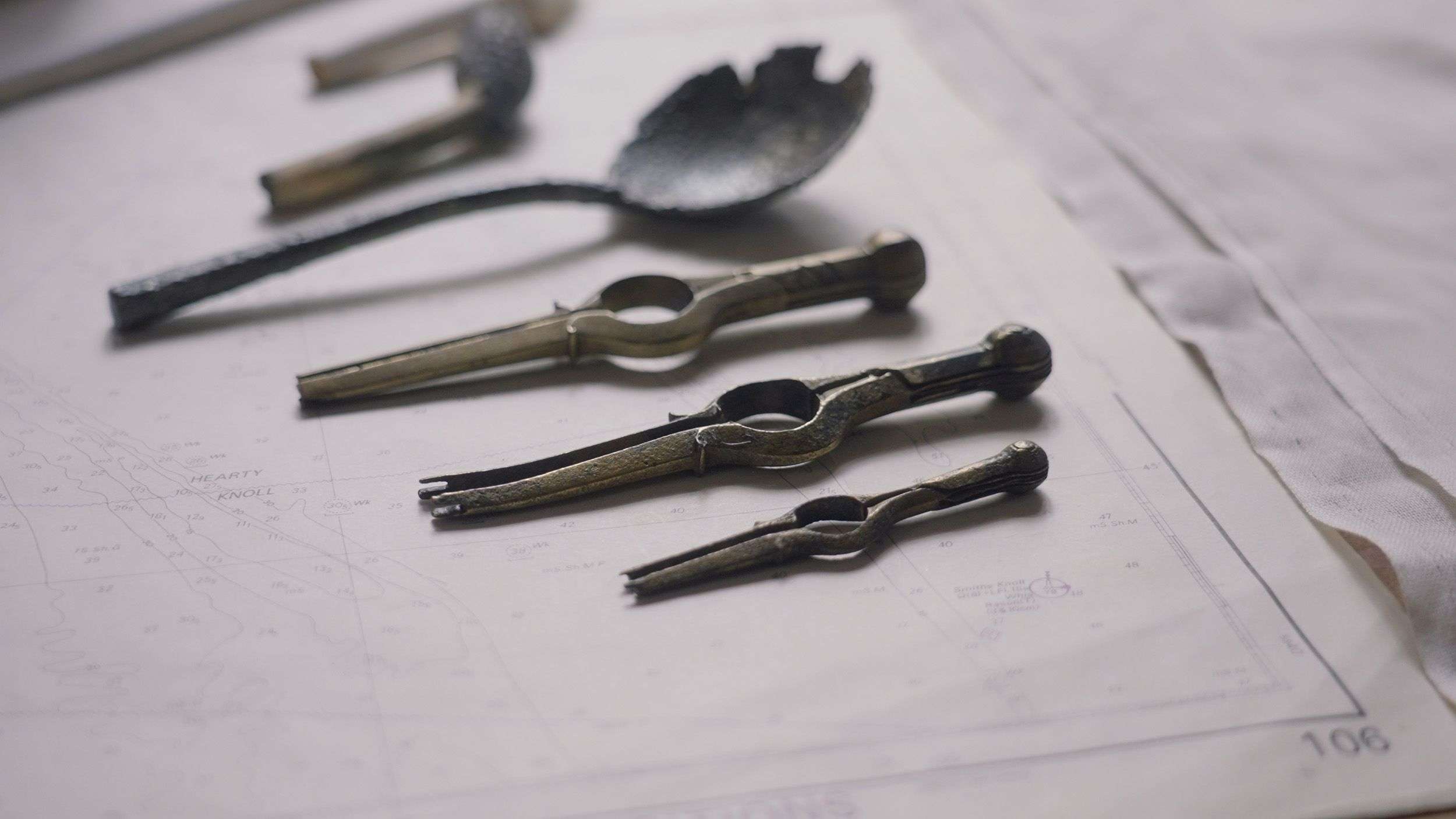 A conserved metal spoon and navigational instruments