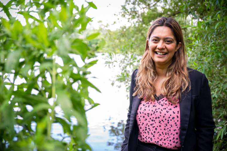 A person smiling with green background