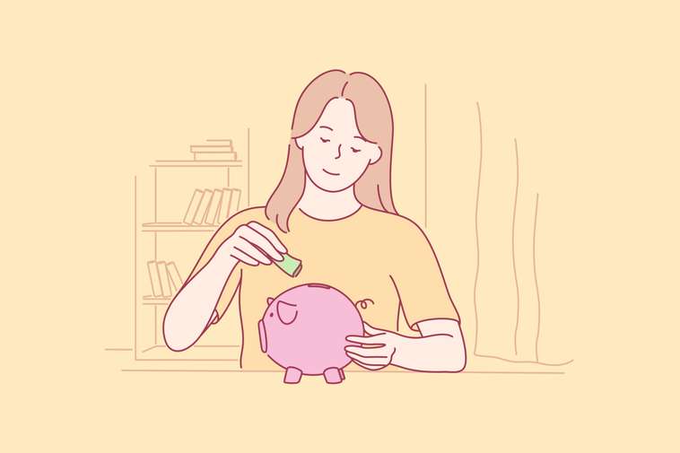 woman putting money into a money box