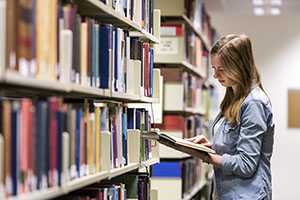 student reading publications