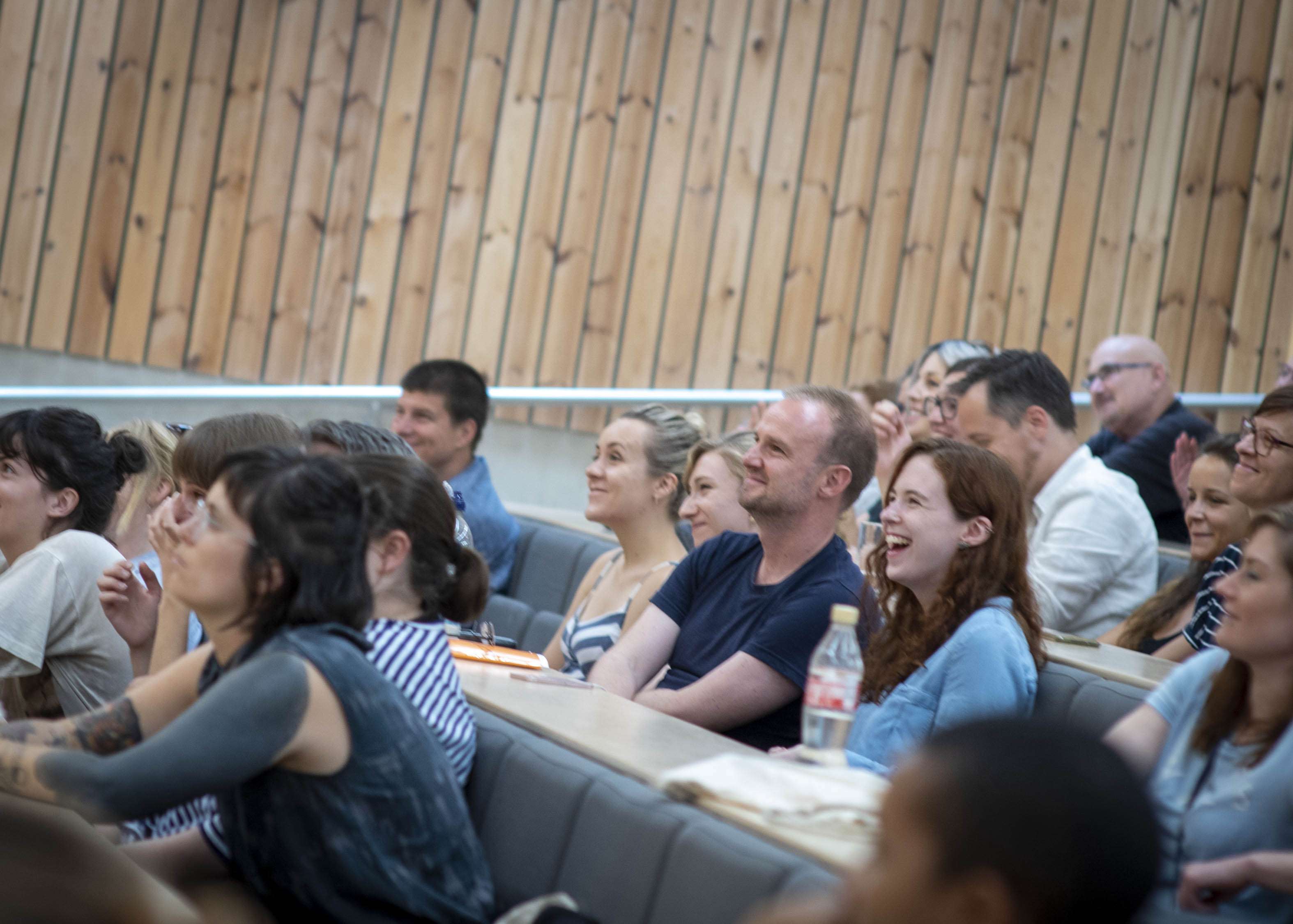 Photo of audience laughing during a panel event
