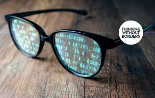 Image of a pair of glasses with overlaid computer code in the lenses
