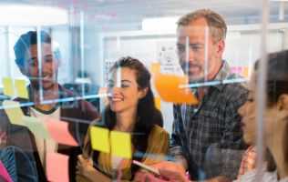 Business people looking at sticky notes
