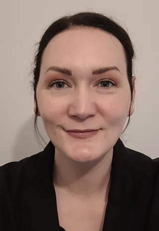 A portrait photo of someone smiling at the camera.
