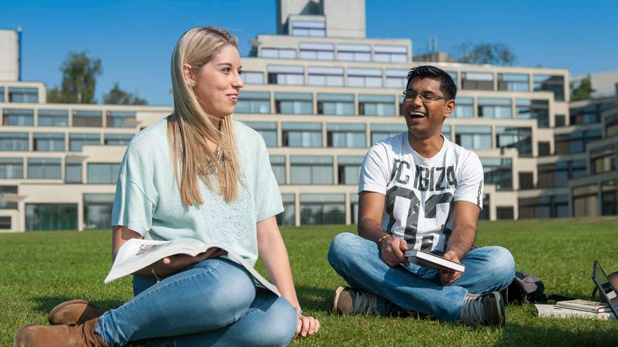 Student sitting outside student accommodation Norfolk Terrace Ziggurats