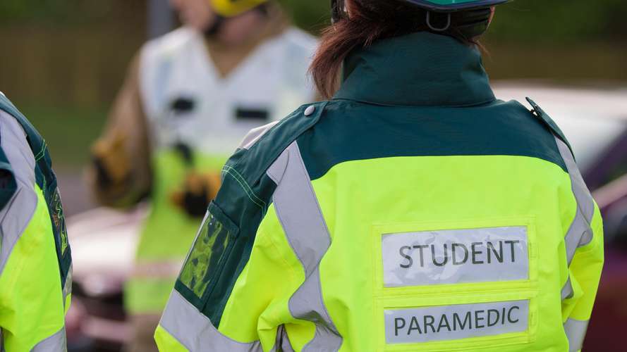 Student paramedic showing back of jacket