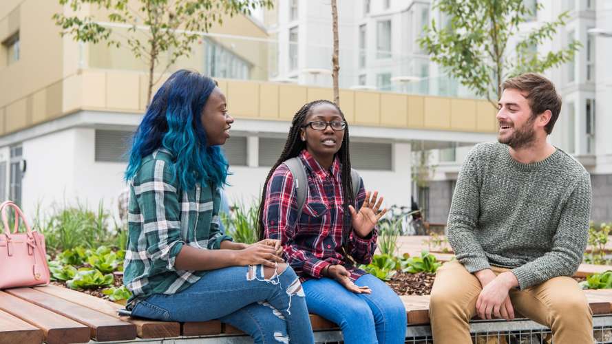 Group of three students talking