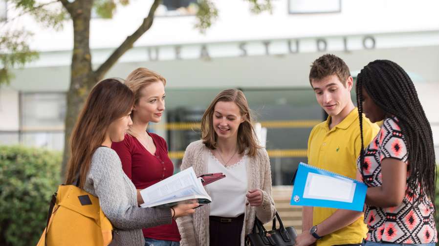 Students talking outside the Drama Studio on Campus - School of Drama, Literature and Creative Writing