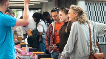 Young person and parents talking to UEA staff