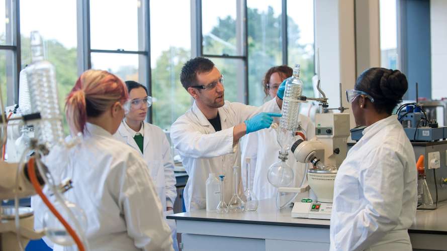 Mature Chemist student in a practical session on campus