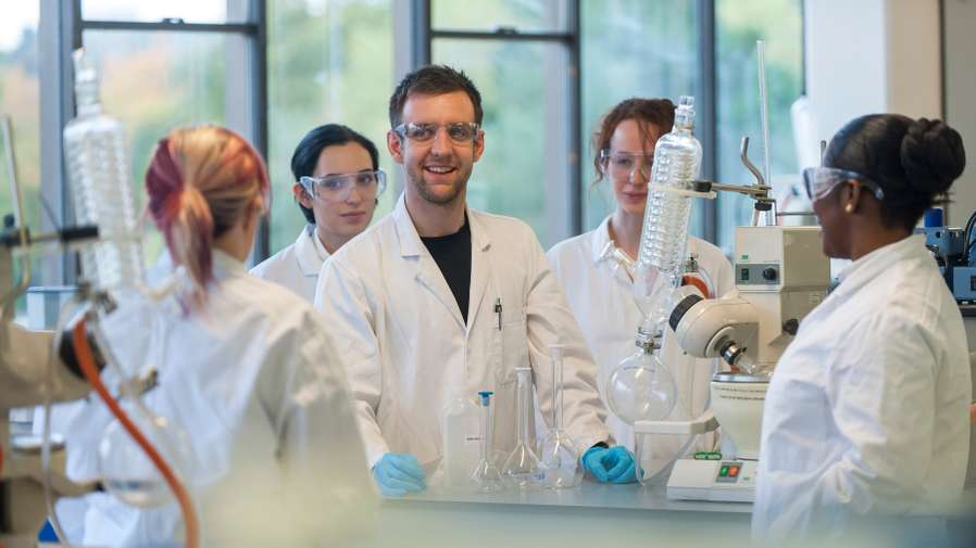 Mature Chemist student in a practical session on campus