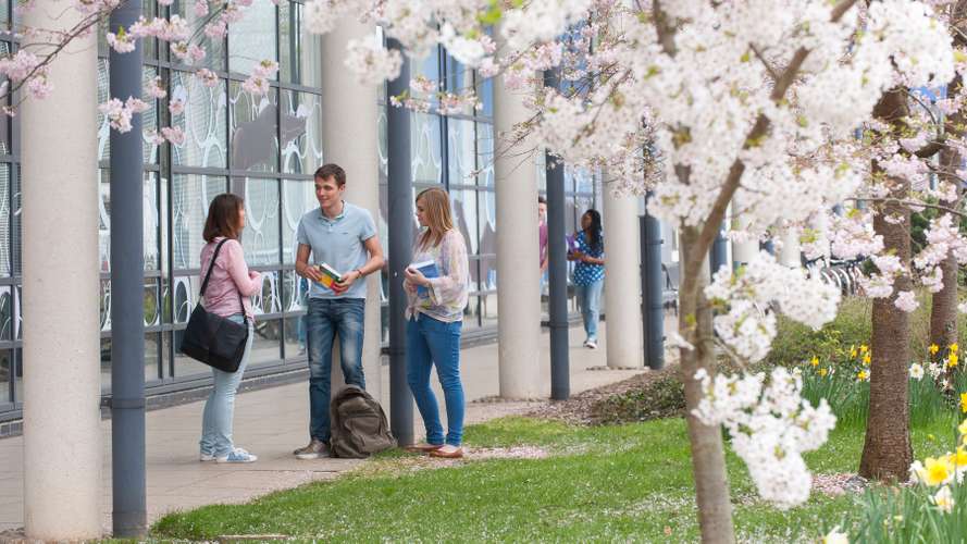 Students outside the Sportspark on campus in the Spring