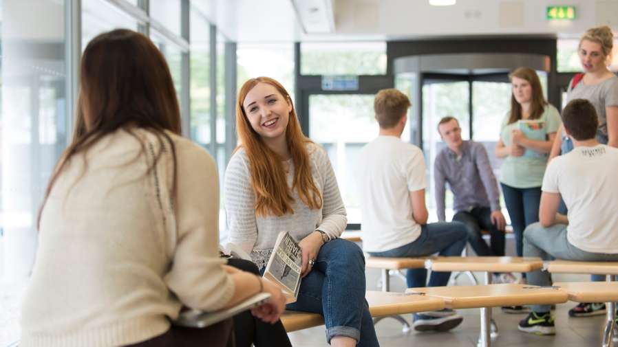 Students talking in the reception of the Thomas Paine Study Centre on Campus