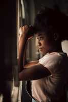 young woman looking out of window