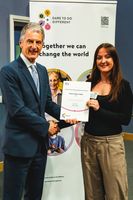 Naomi shaking hands with the VC holding her award