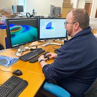 photo of Associate in front of computer screen