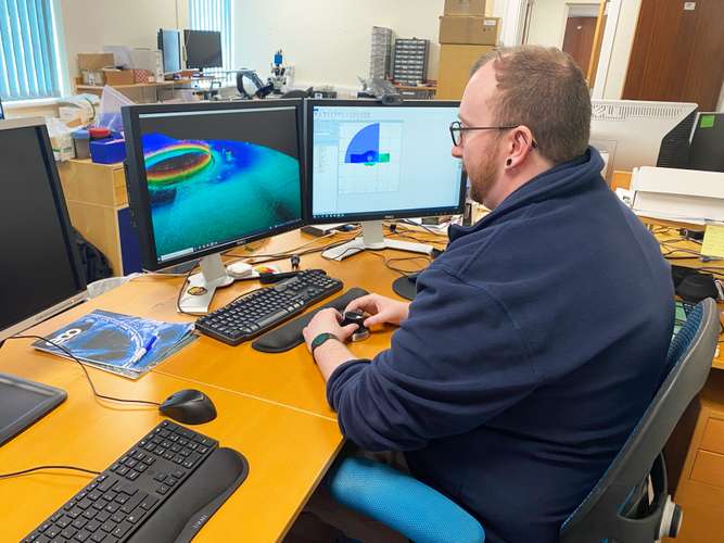 photo of Associate in front of computer screen