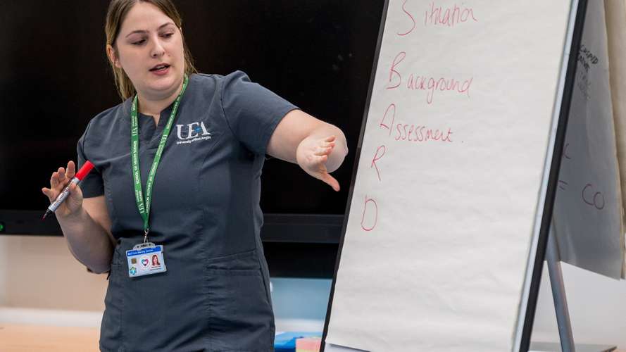 Nursing student reading from a flip chart