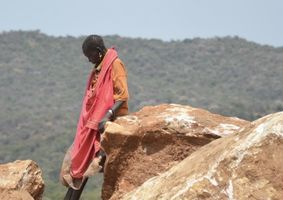 Woman leaning on a rock