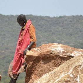 Woman leaning on a rock