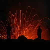 Volcano erupting at night