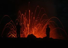 Volcano erupting at night