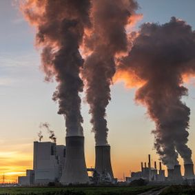 plumes of smoke from industrial chimneys at plant