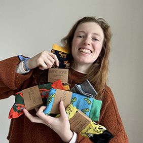 lucy jeffrey holding multicoloured socks 