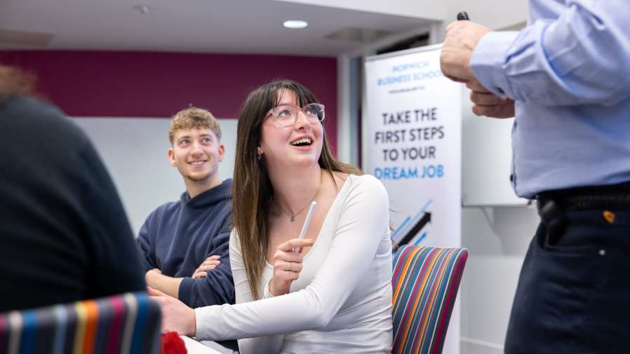 Business students working together in the seminar session in Thomas Paine Study Center