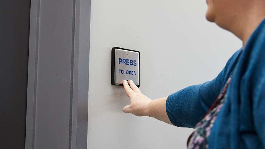 Dr Katherine Deane using electric door to teaching room