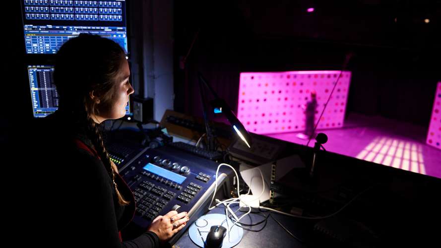 Drama student learning about lighting and sound for their production on campus.
