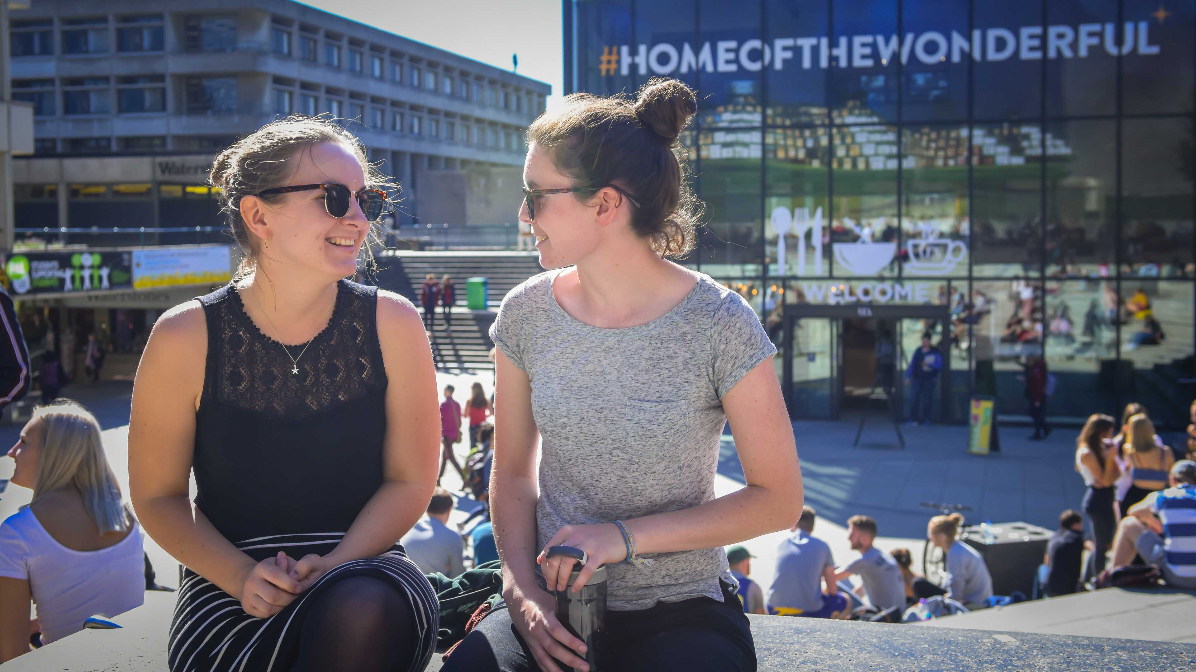 Two students chatting in the Square
