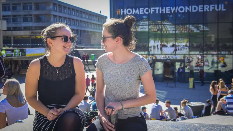 Two students chatting in the Square