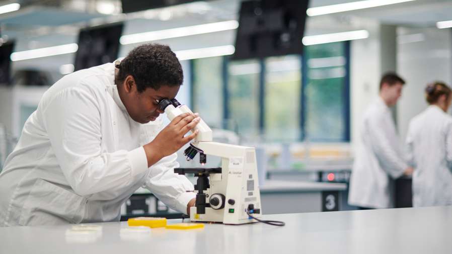 Mature students of Biology in New Science Building laboratory conducting an experiment.