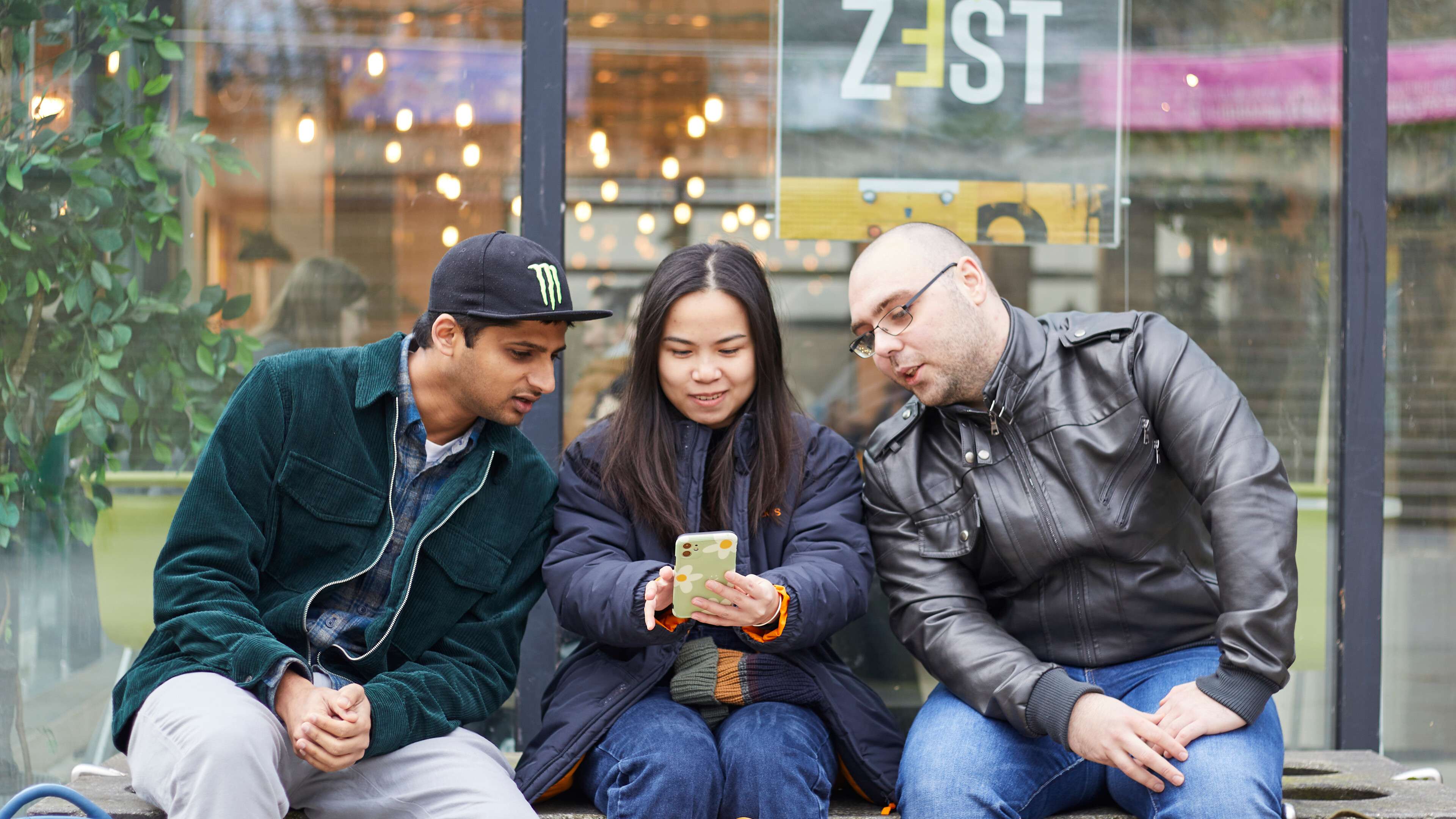 Students in the Square looking at a phone