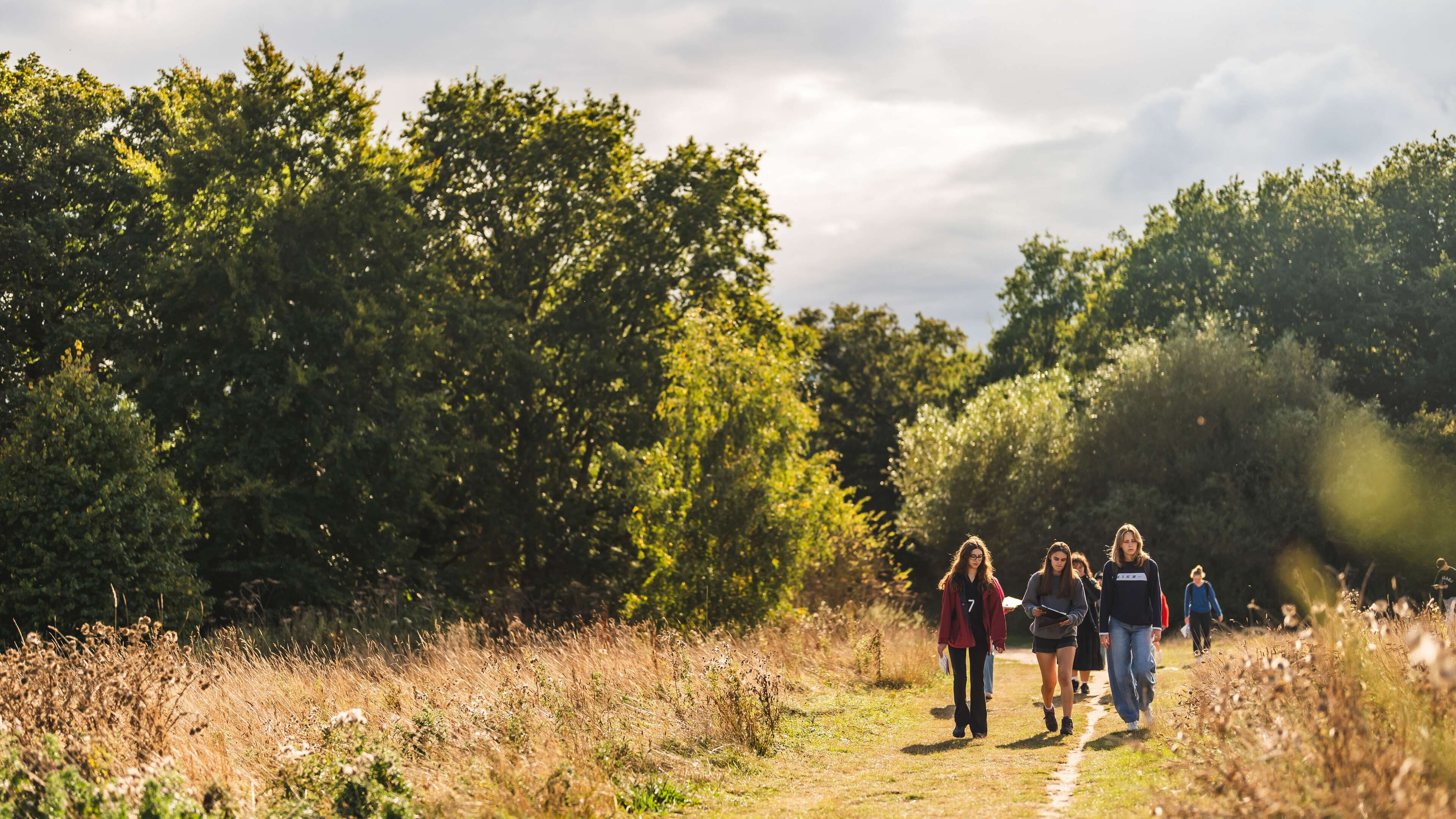 Environmental science and geography students on campus, taking part in an outdoor field activity