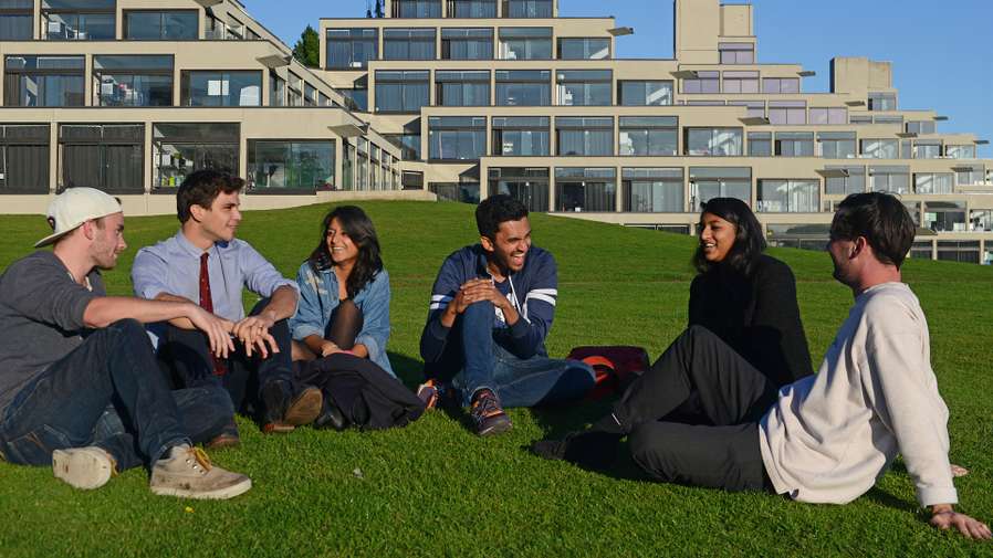 Students socialising on grass