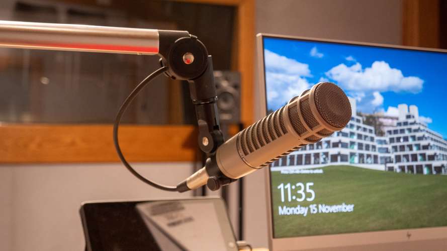 Microphone and computer in the audio/podcast studio of UEA's Broadcast House.